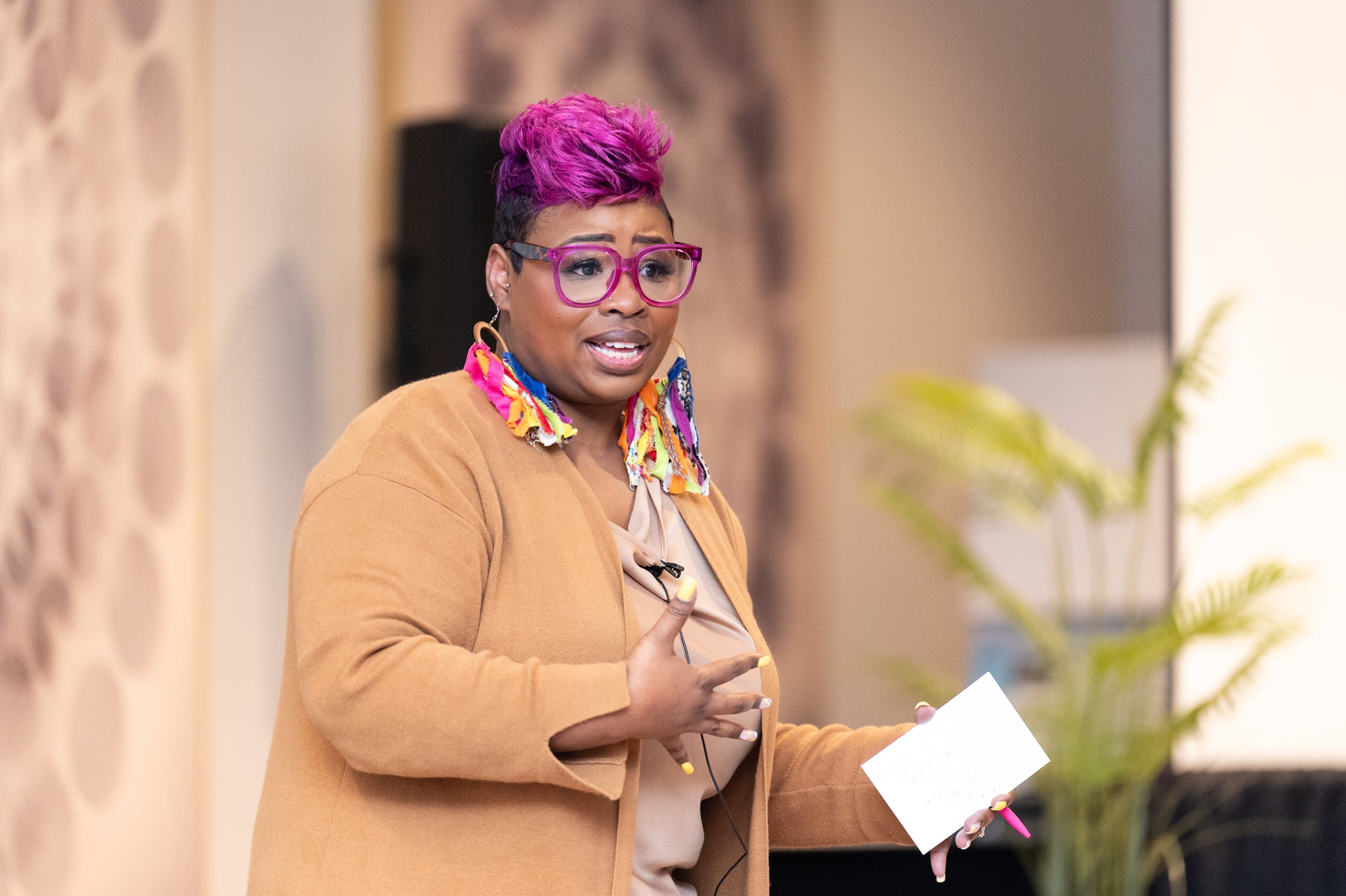 LaShawn Davis speaking on stage at UNPLUG
