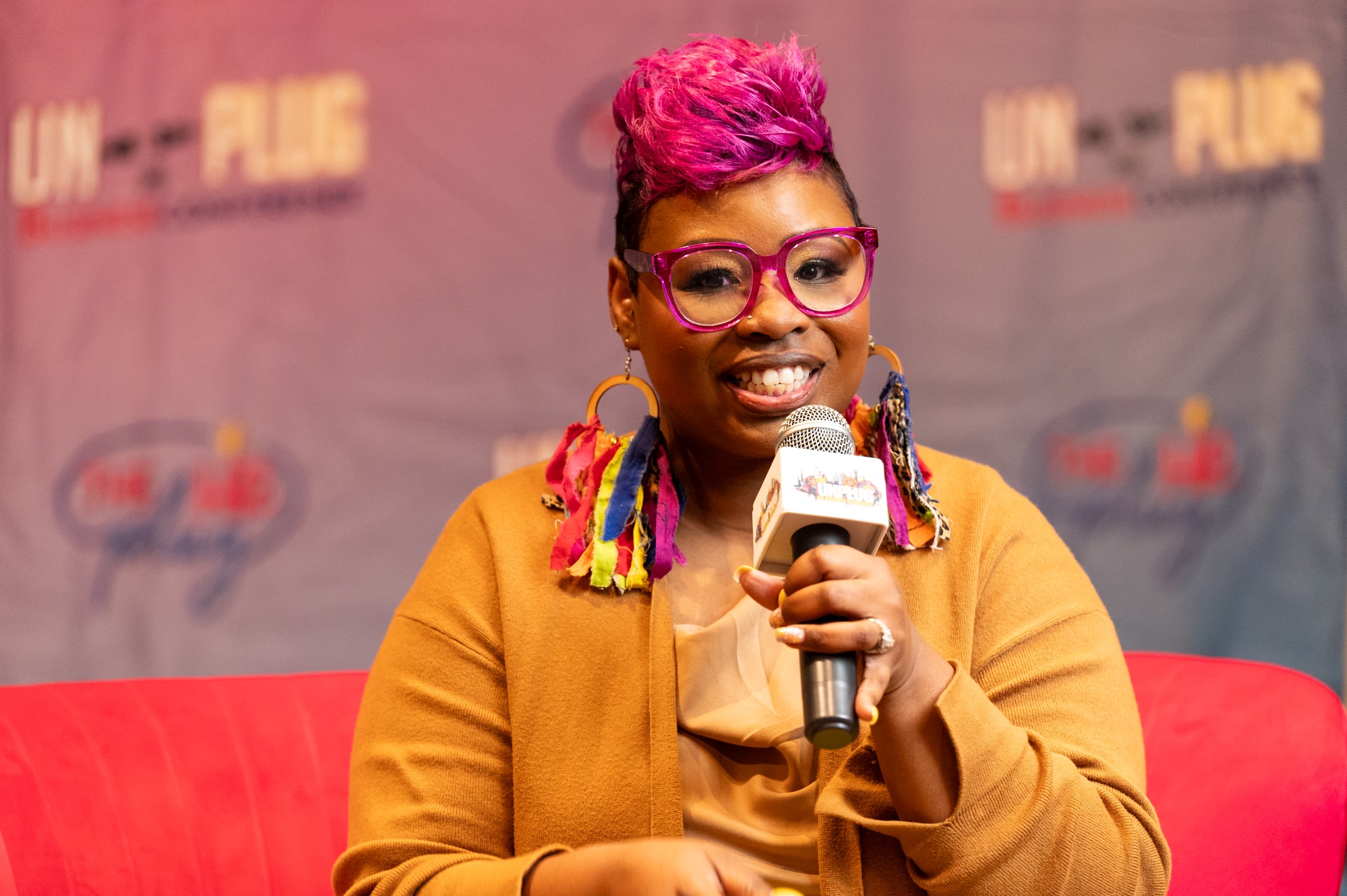 LaShawn Davis speaking into a microphone at UNPLUG